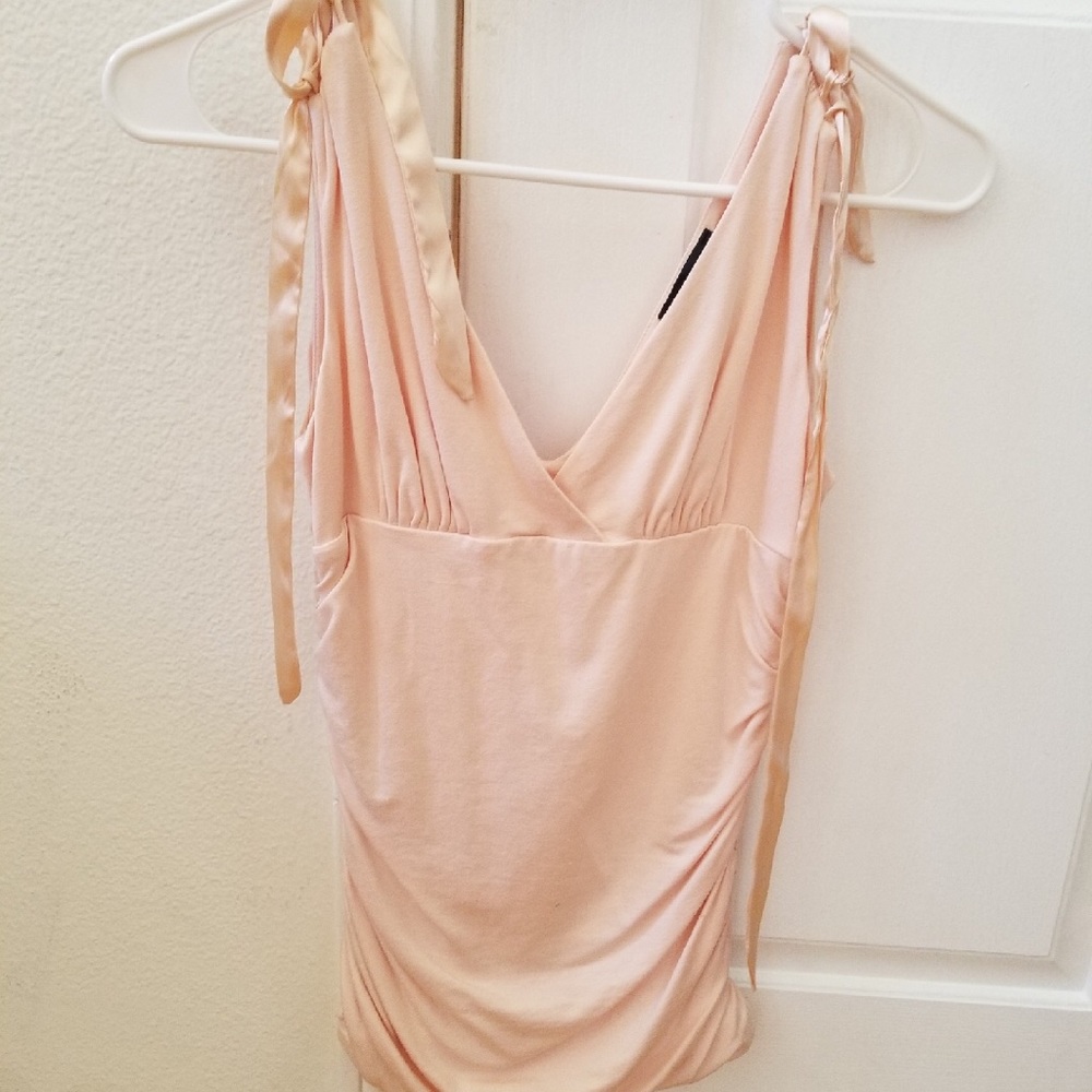 Light pink v-neck top.